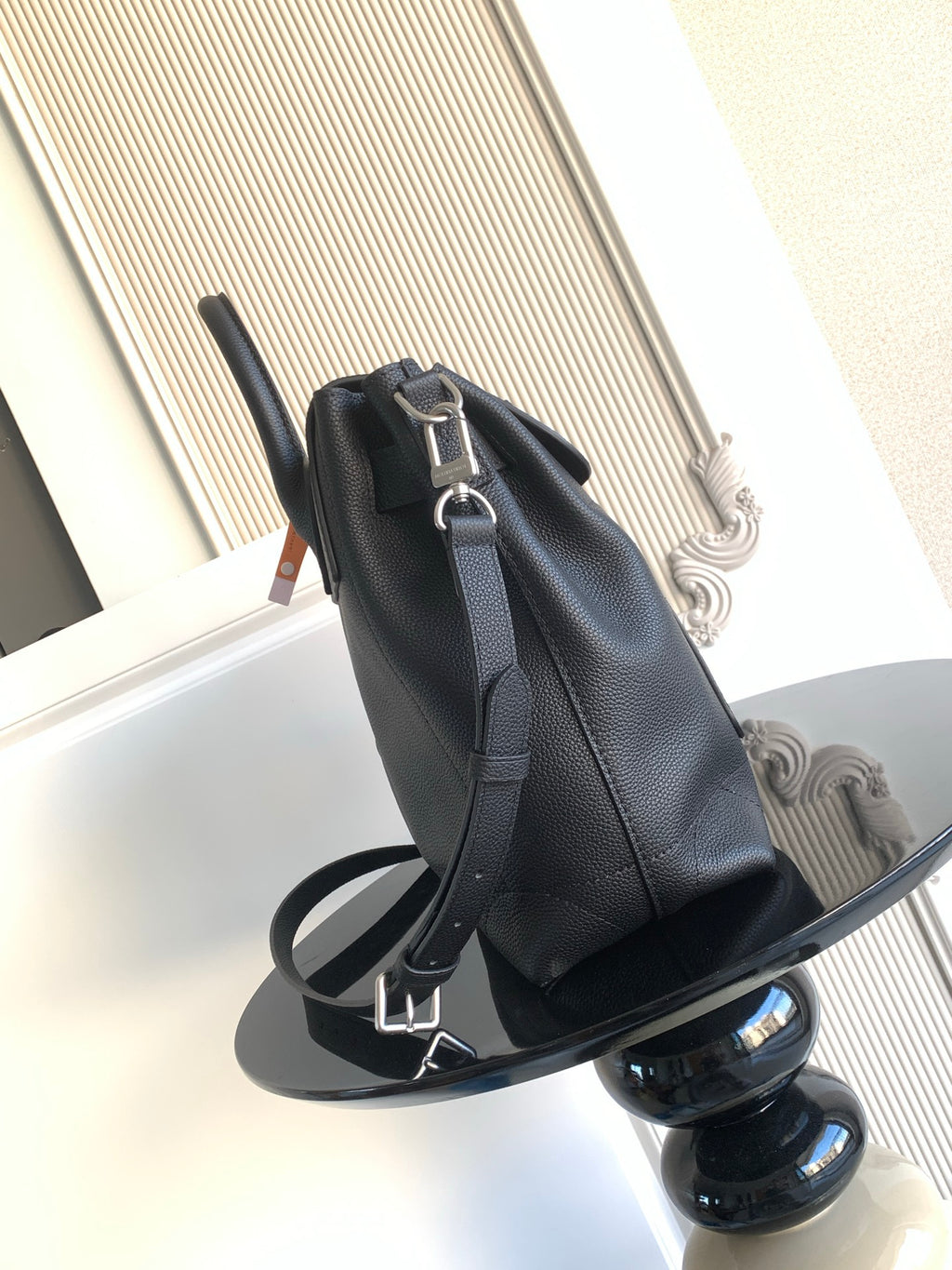 Men’s black leather bag with shoulder strap and silver buckle hardware