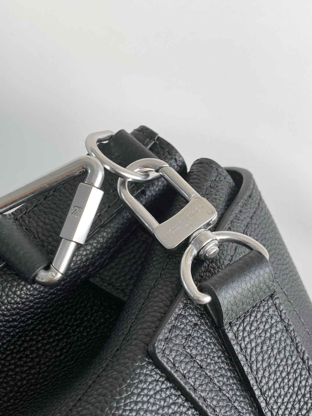 Black leather bag strap with silver buckle and D-ring hardware