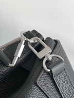 Black leather bag strap with silver buckle and D-ring hardware