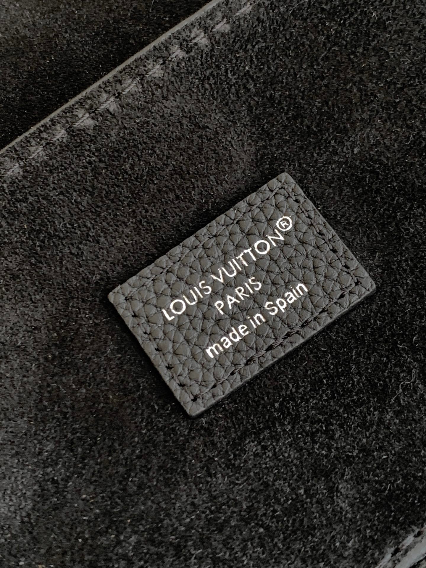 Louis Vuitton Paris label on black leather lining, made in Spain