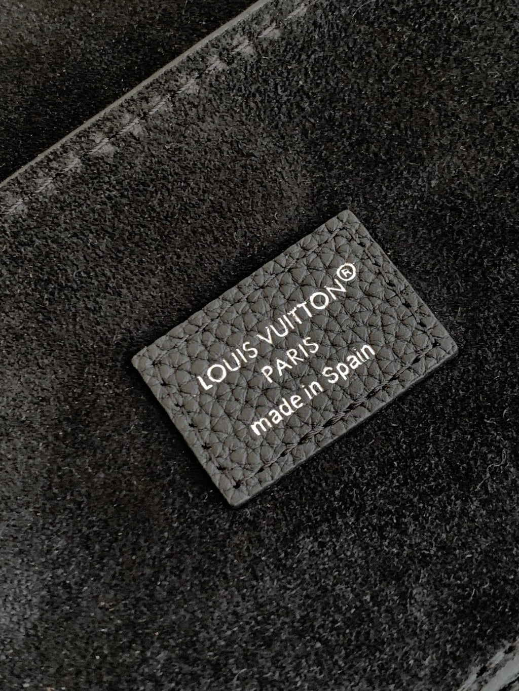 Black leather handbag with Louis Vuitton “Made in Spain” authenticity label