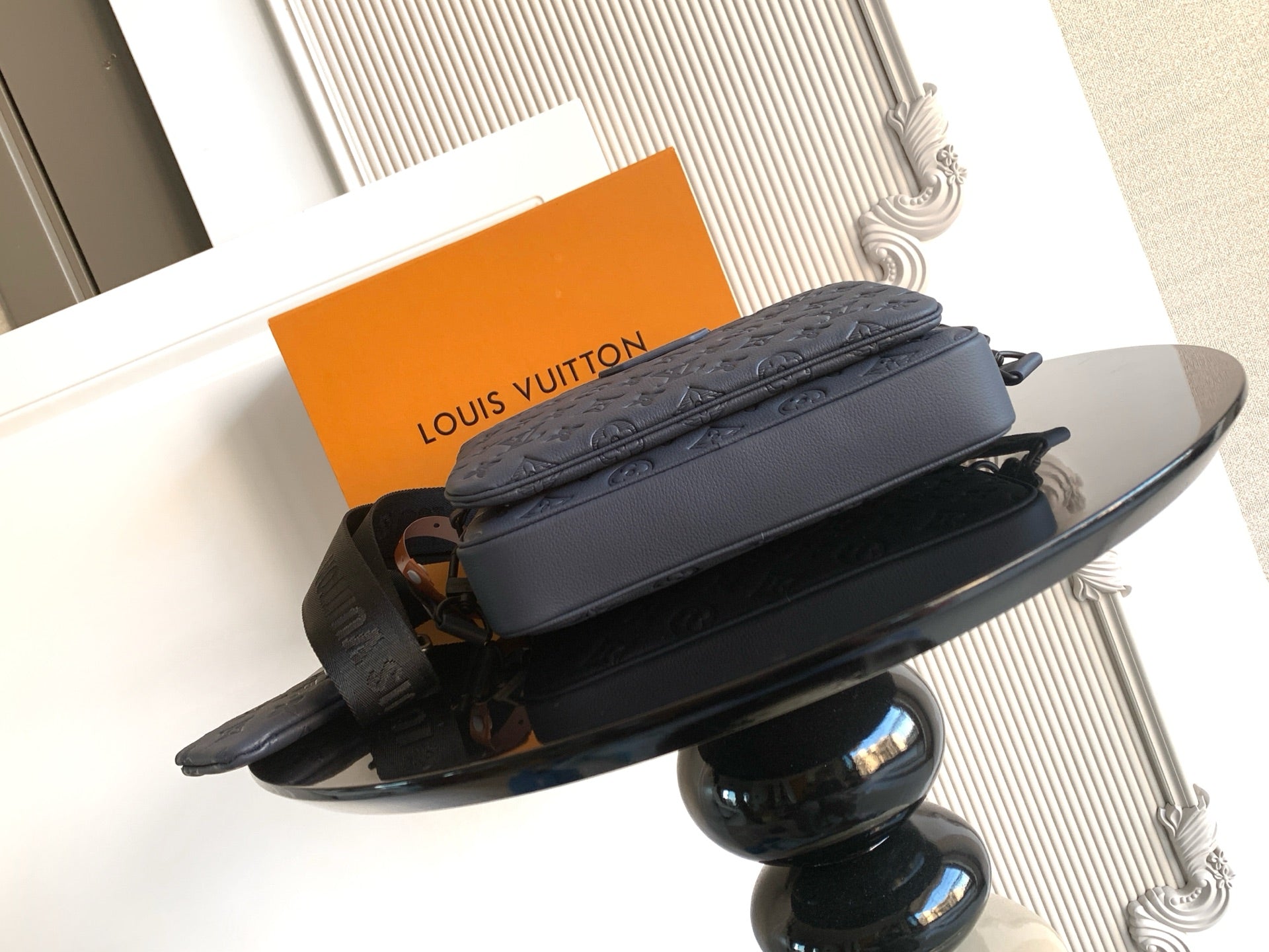 Rectangular crossbody bag in dark blue with monogram texture and long adjustable strap