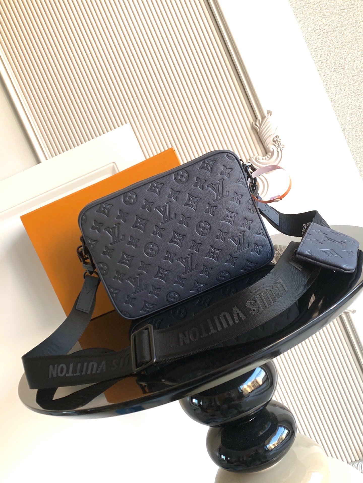 Dark blue monogram shoulder bag with zip closure and crossbody strap