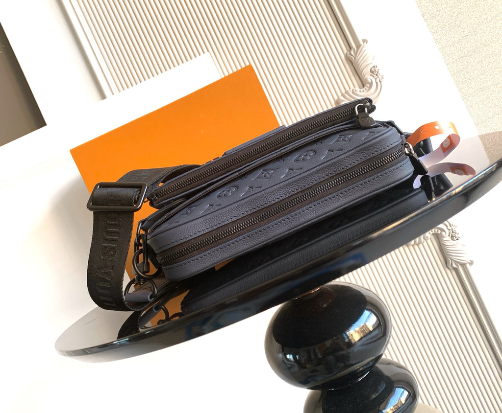 Dark blue monogram zip shoulder bag with crossbody strap and side pocket