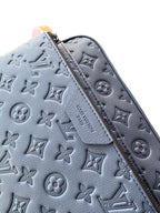 Light blue monogram-embossed crossbody bag panel with zip track and stitching
