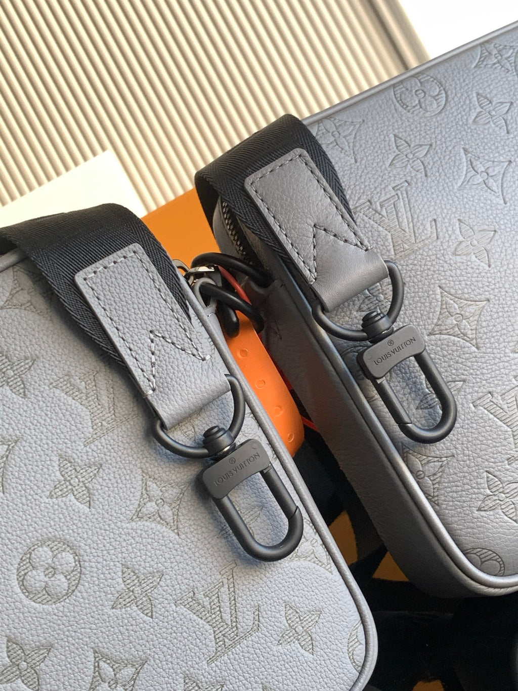 Louis Vuitton monogram crossbody bag, light gray with stitched tabs and metal snap hooks