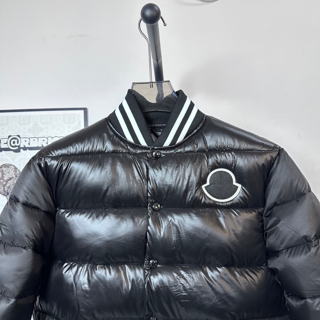 Moncler long puffer jacket, black, front close-up with striped collar and logo