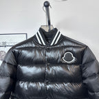 Moncler long puffer jacket, black, front close-up with striped collar and logo