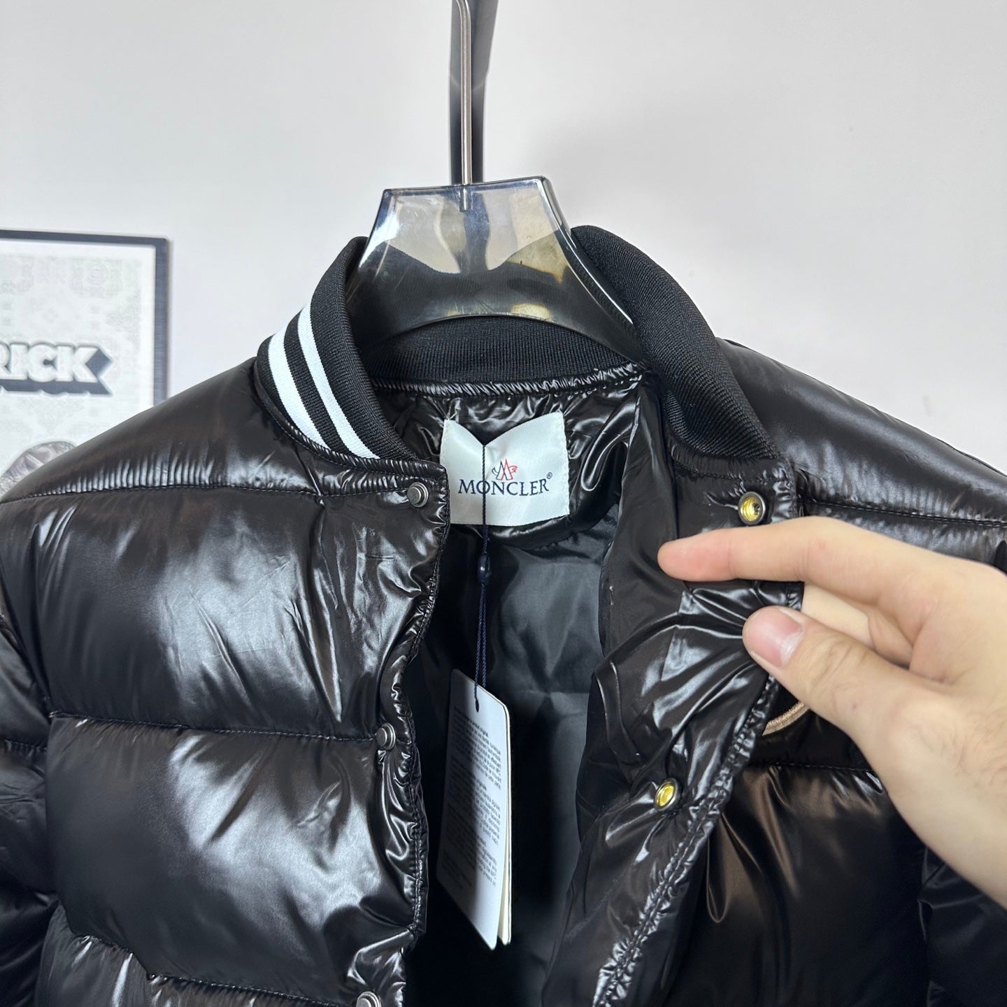 Moncler long puffer jacket neckline close-up, zip front, striped collar, tag