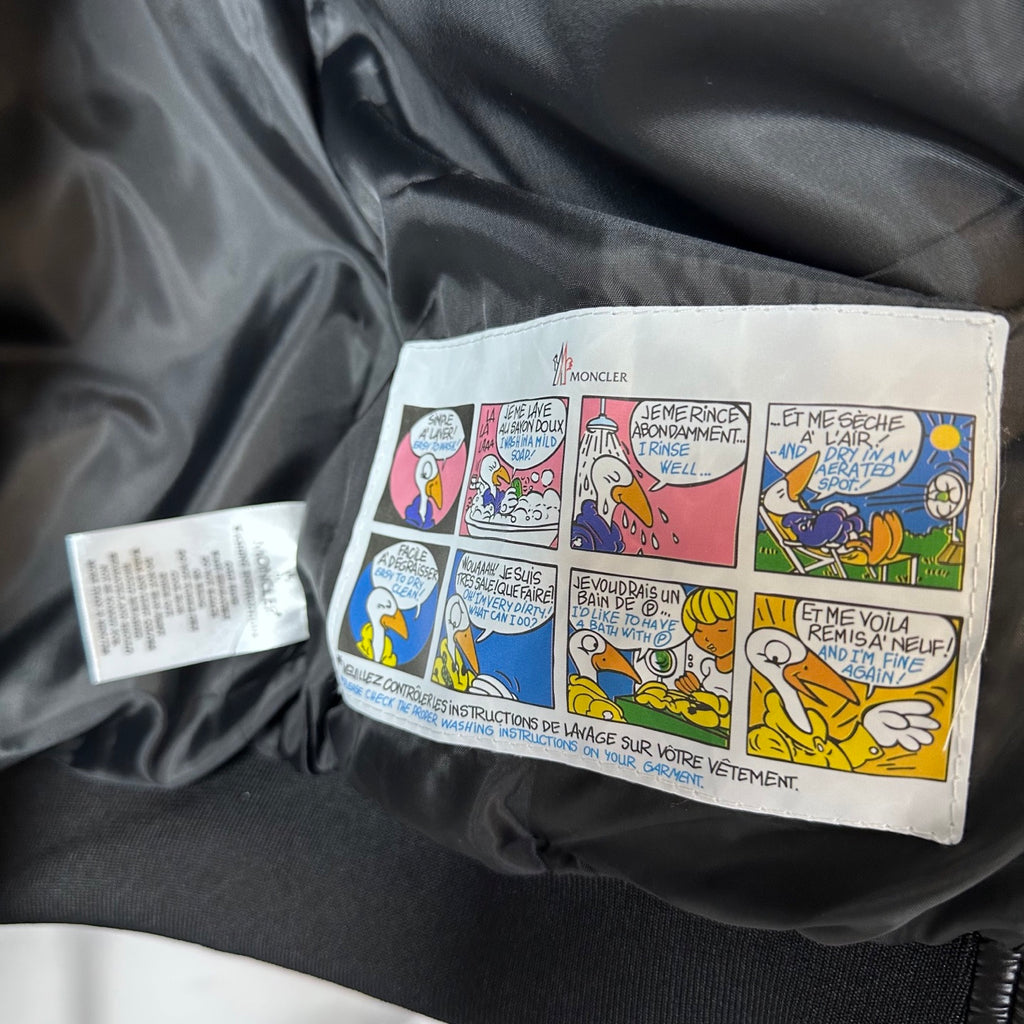 Moncler long puffer jacket inside label pouch with care instructions