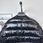 Moncler long puffer jacket, black, back close-up with ribbed collar and stripes