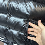 Moncler long puffer jacket side close-up, snap buttons and quilted fabric