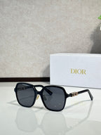 Dior sunglasses with black square frames and dark gray lenses, metal logo detail