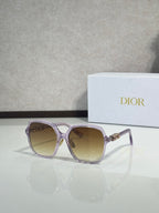 Dior sunglasses with purple-tinted square frames and golden lenses, gold logo detail