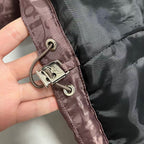 Adjustable drawcord with metal toggles on mauve puffer jacket cuff