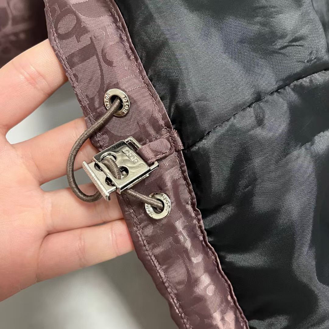 Adjustable drawcord with metal toggles on mauve puffer jacket cuff