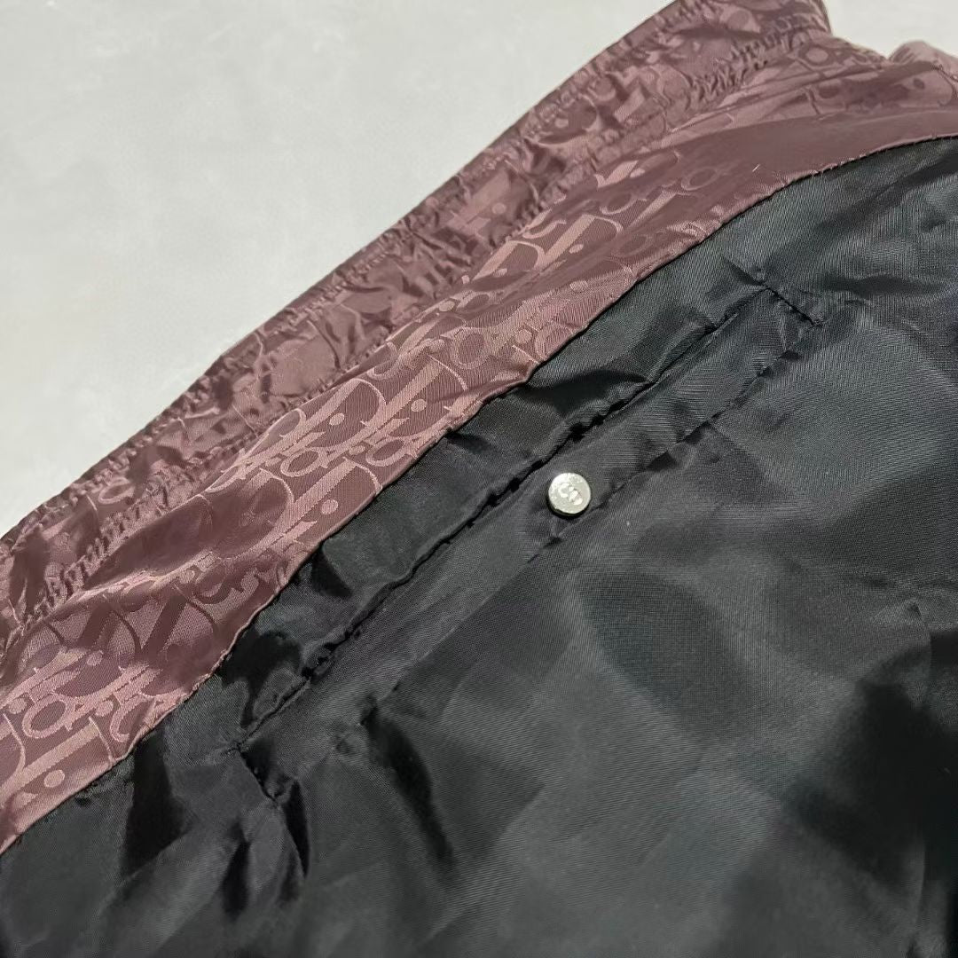 Mauve puffer jacket side seam with zipper edge and snap button