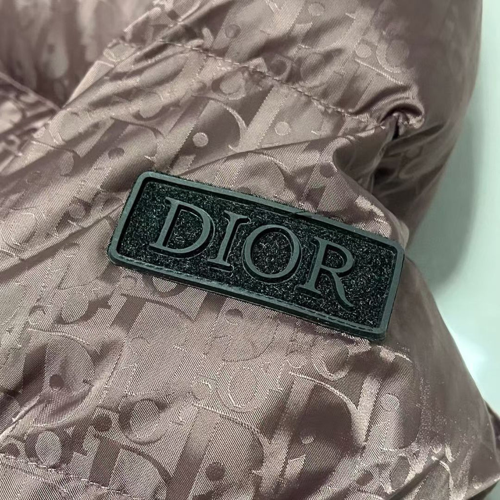 Dior logo patch on mauve puffer jacket sleeve