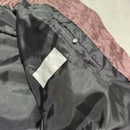 Mauve puffer jacket front with snap button and white brand label