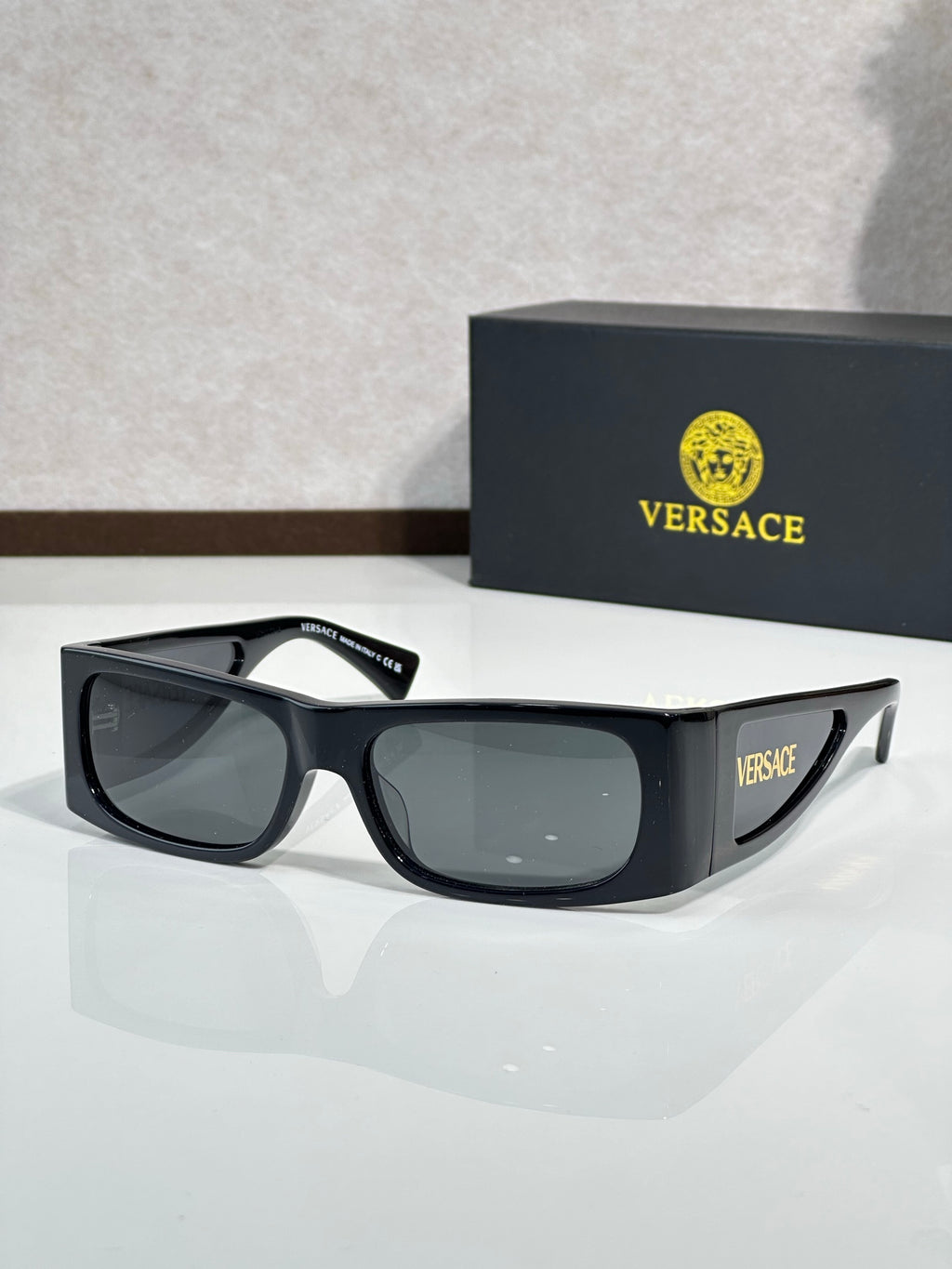 Versace sunglasses with black frame and smoked lenses