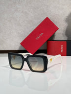 Black oversized square sunglasses with dark lenses, Prada temple logo