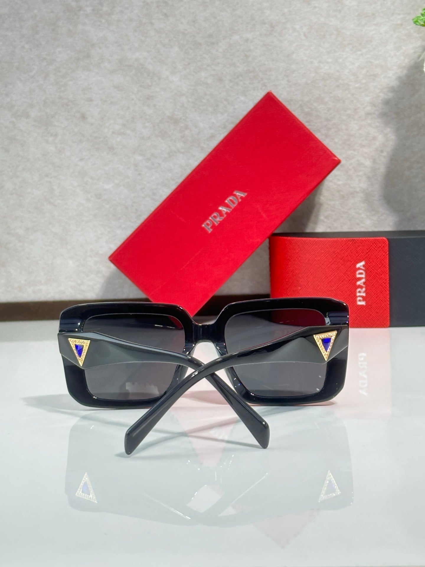 Black oversized square sunglasses with angular temples, Prada logo detail