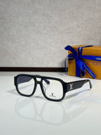 Black fashion sunglasses with dark lenses and gold logo on temples, front view