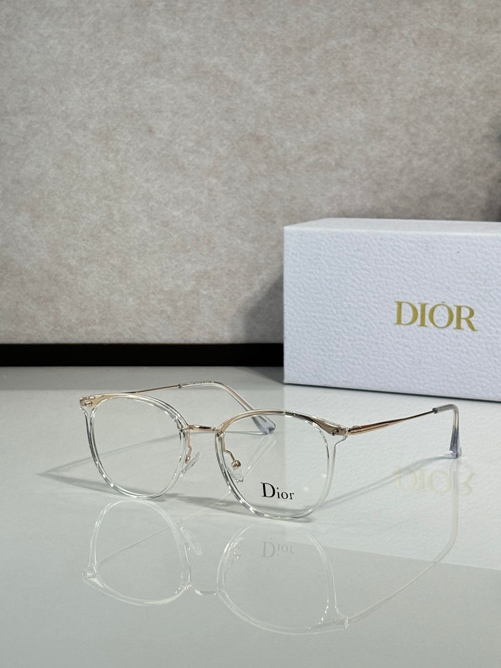 Dior eyeglasses with clear/metal round frames and clear lenses, logo on bridge