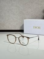 Dior eyeglasses with gold brown round frames and clear lenses, logo on lens