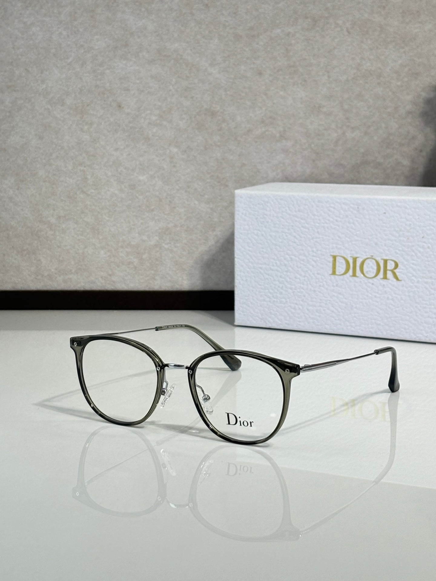 Dior eyeglasses with dark green round frames and clear lenses, logo at front