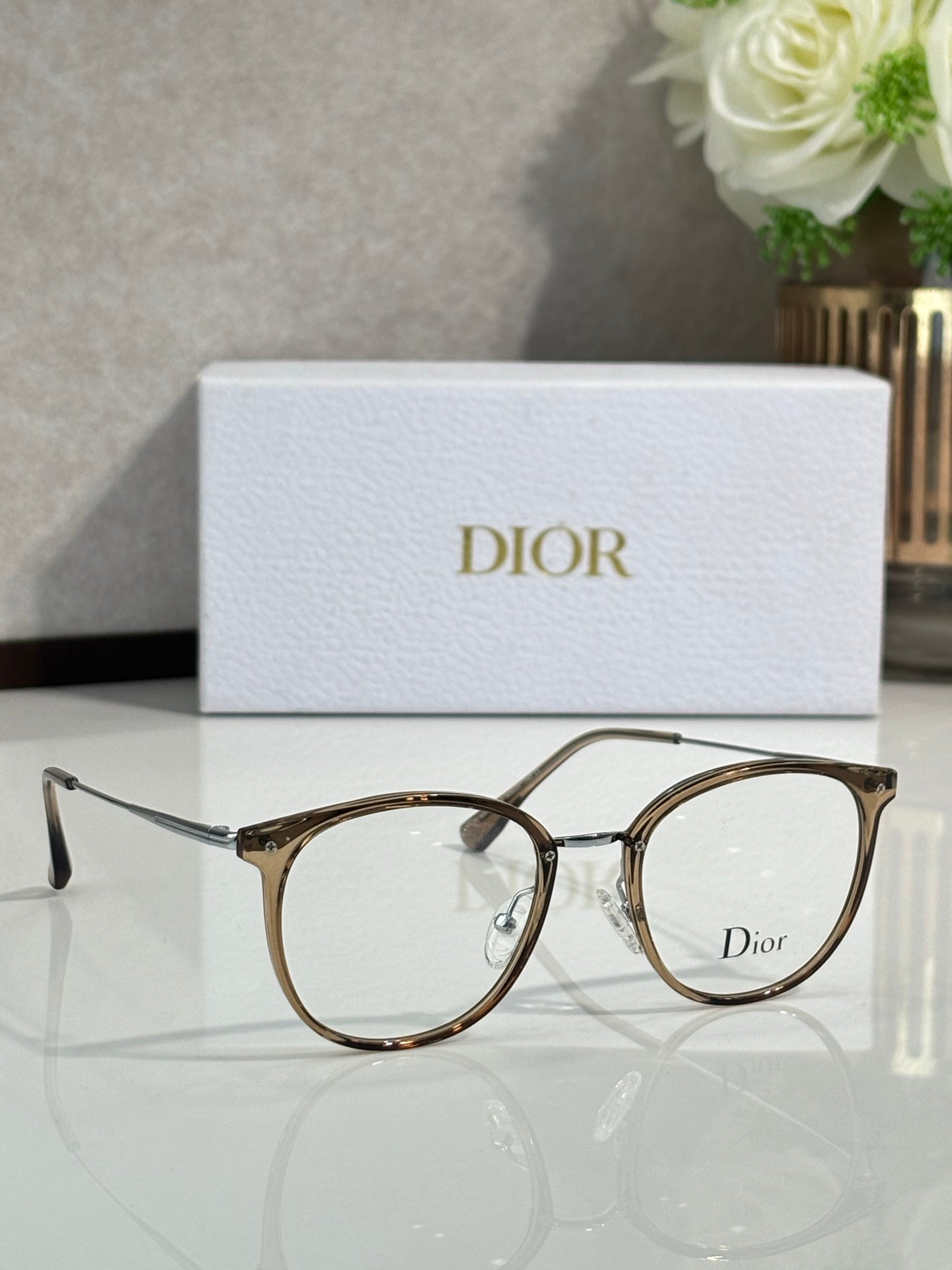 Dior eyeglasses with dark brown round frames and clear lenses, side temple details