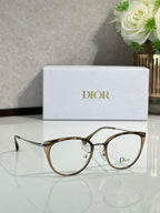 Light brown round eyeglasses with metal bridge and Dior logo on lens