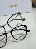 Black round eyeglass frames with Dior logo on lens, close-up view