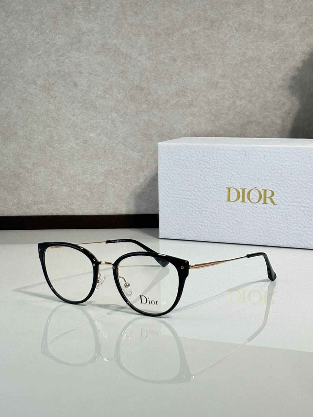 Black round eyeglasses with gold-tone temples and Dior logo on front
