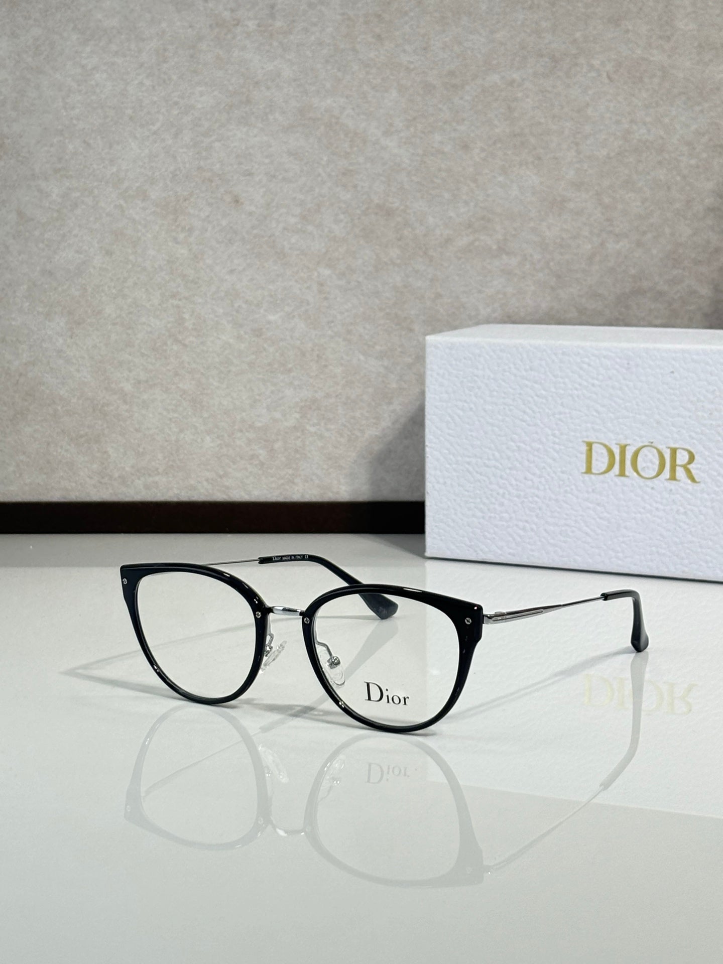 Black round eyeglasses with slim metal temples and Dior logo on front