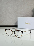 Brown tortoiseshell round eyeglasses with gold-tone temples and Dior logo on lens