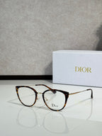 Brown tortoiseshell round eyeglasses with gold-tone temples and Dior logo on lens