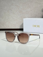 Sunglasses with translucent silver frame and brown gradient lenses, cat-eye shape