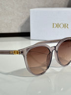 Sunglasses close-up with translucent silver frame and brown gradient lenses, cat-eye shape