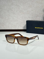 Balenciaga oversized square sunglasses with amber tortoiseshell frame and brown lenses