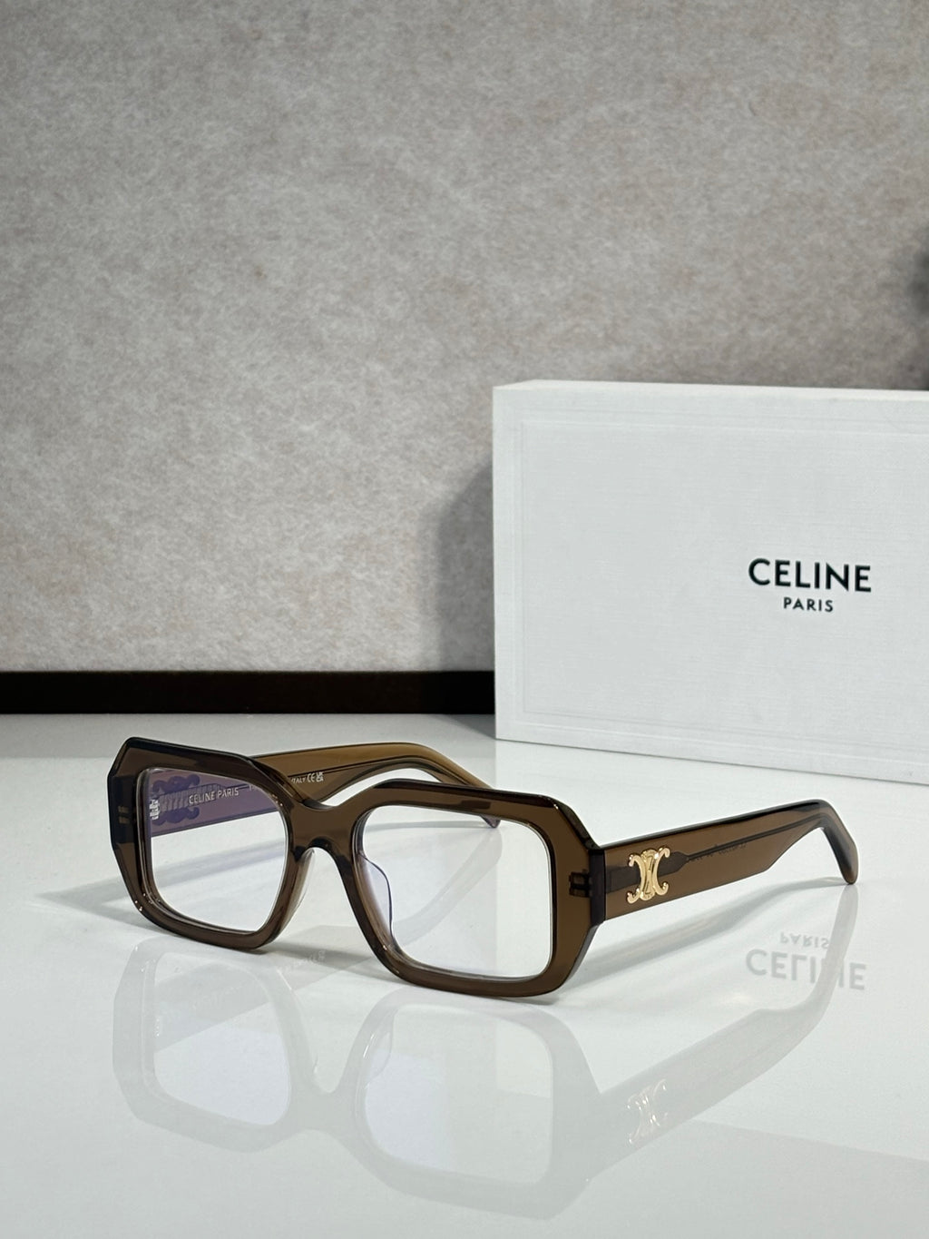 Celine tortoiseshell square eyeglasses with gold logo on temple.