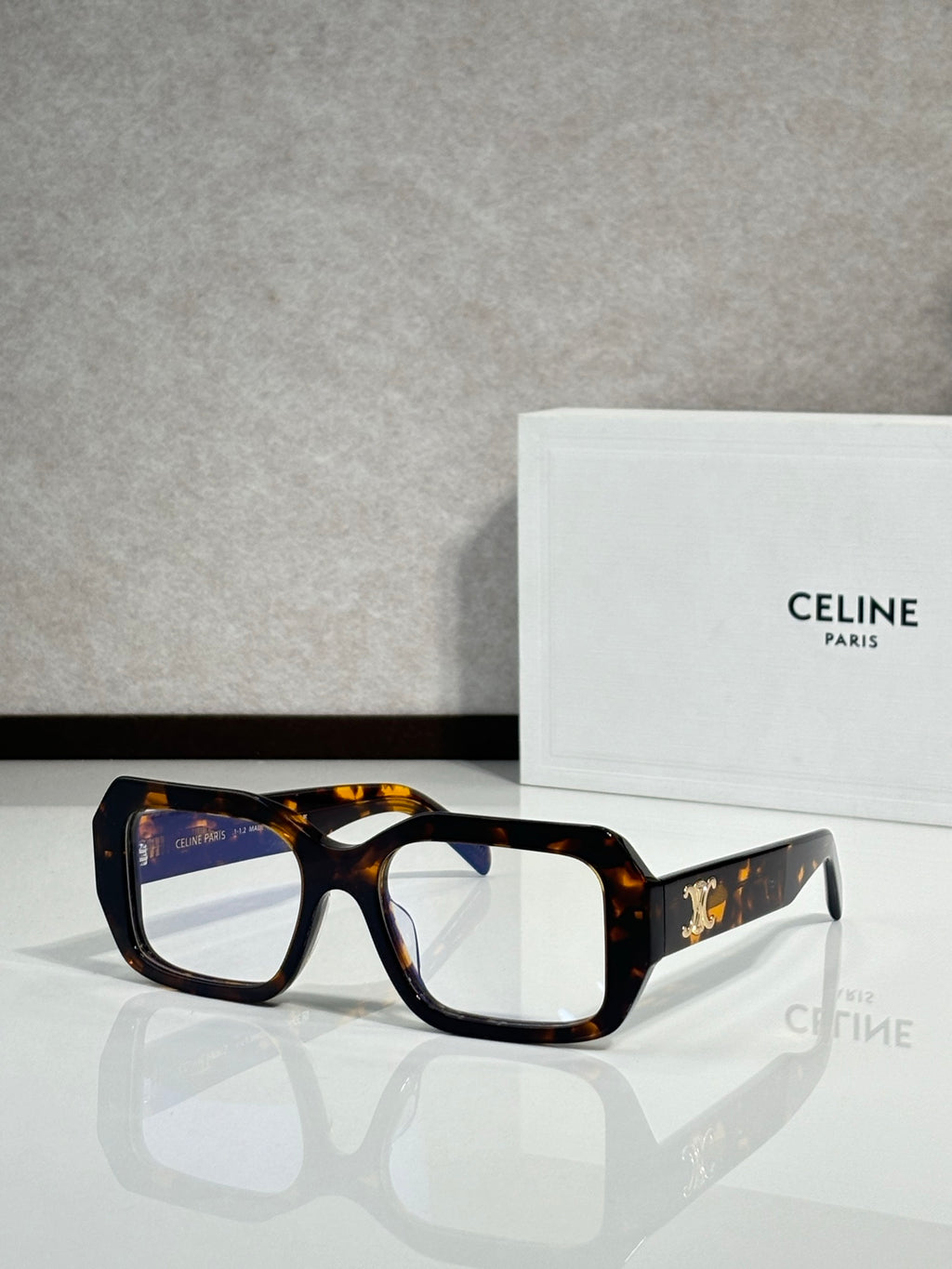 Celine tortoiseshell square eyeglasses with gold logo on temple.
