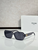 Celine black oversized sunglasses with gold logo on temple.