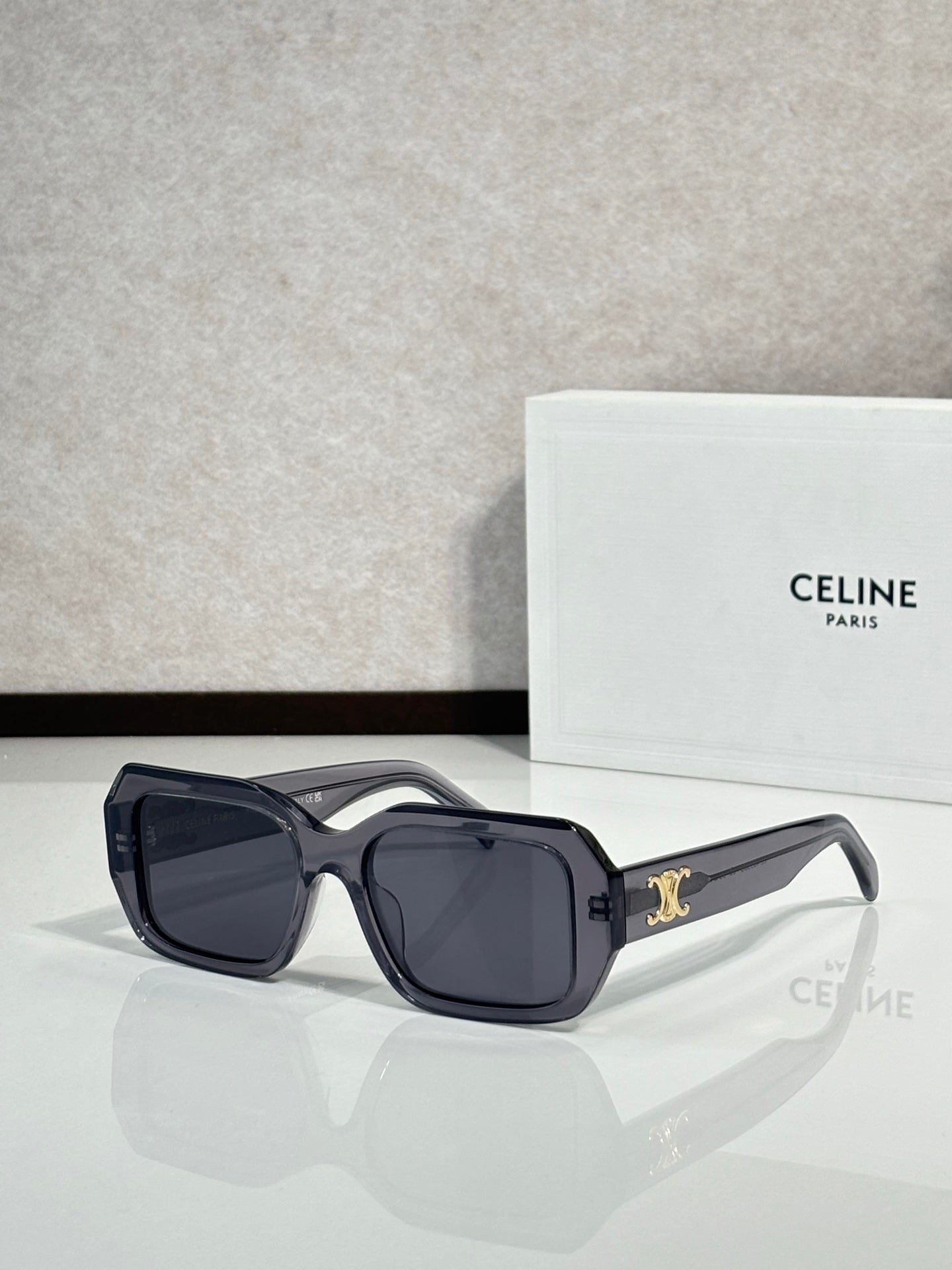 Celine black oversized sunglasses with gold logo on temple.