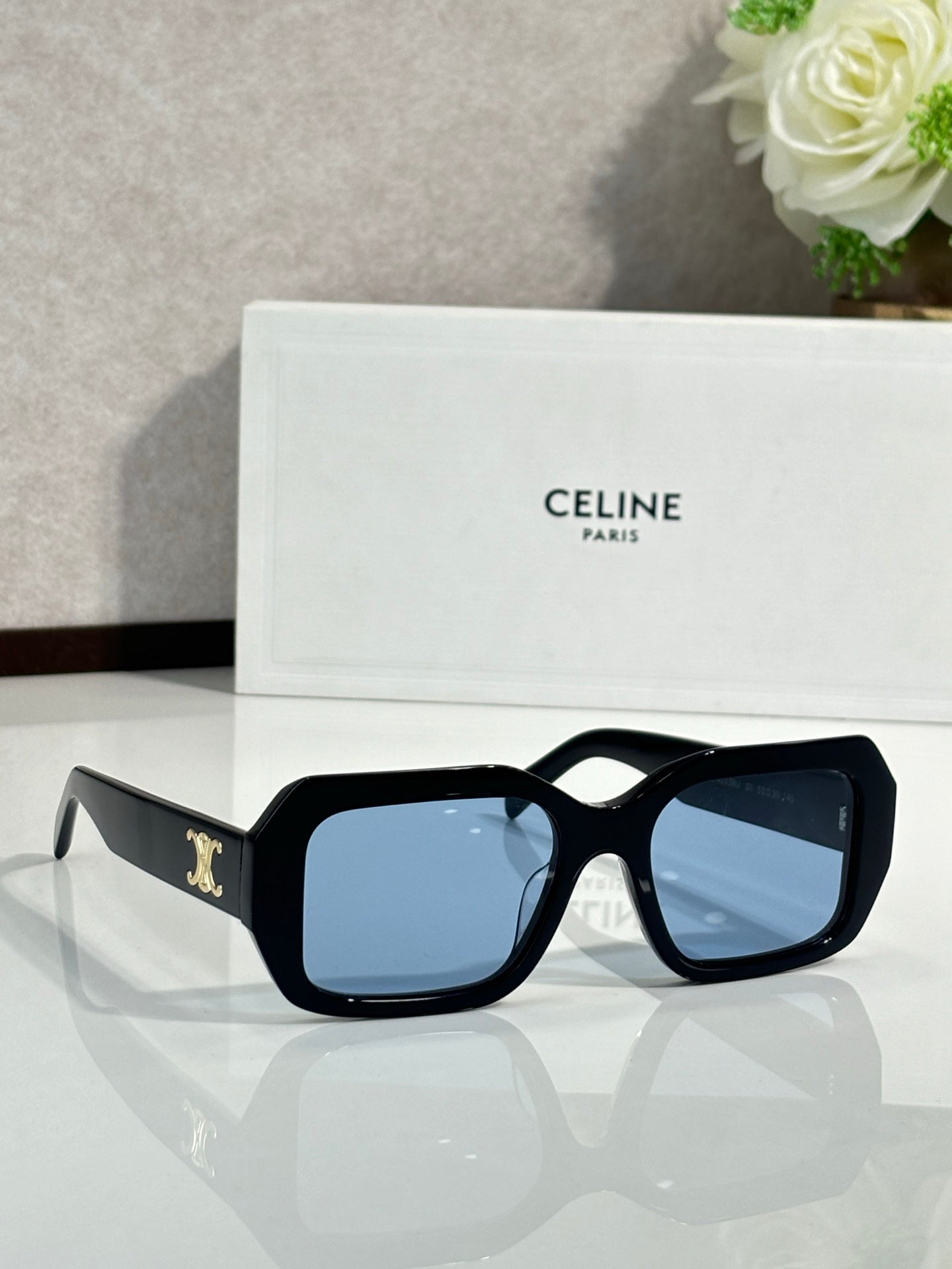 Celine black oversized square sunglasses with light blue lenses and gold logo temple detail