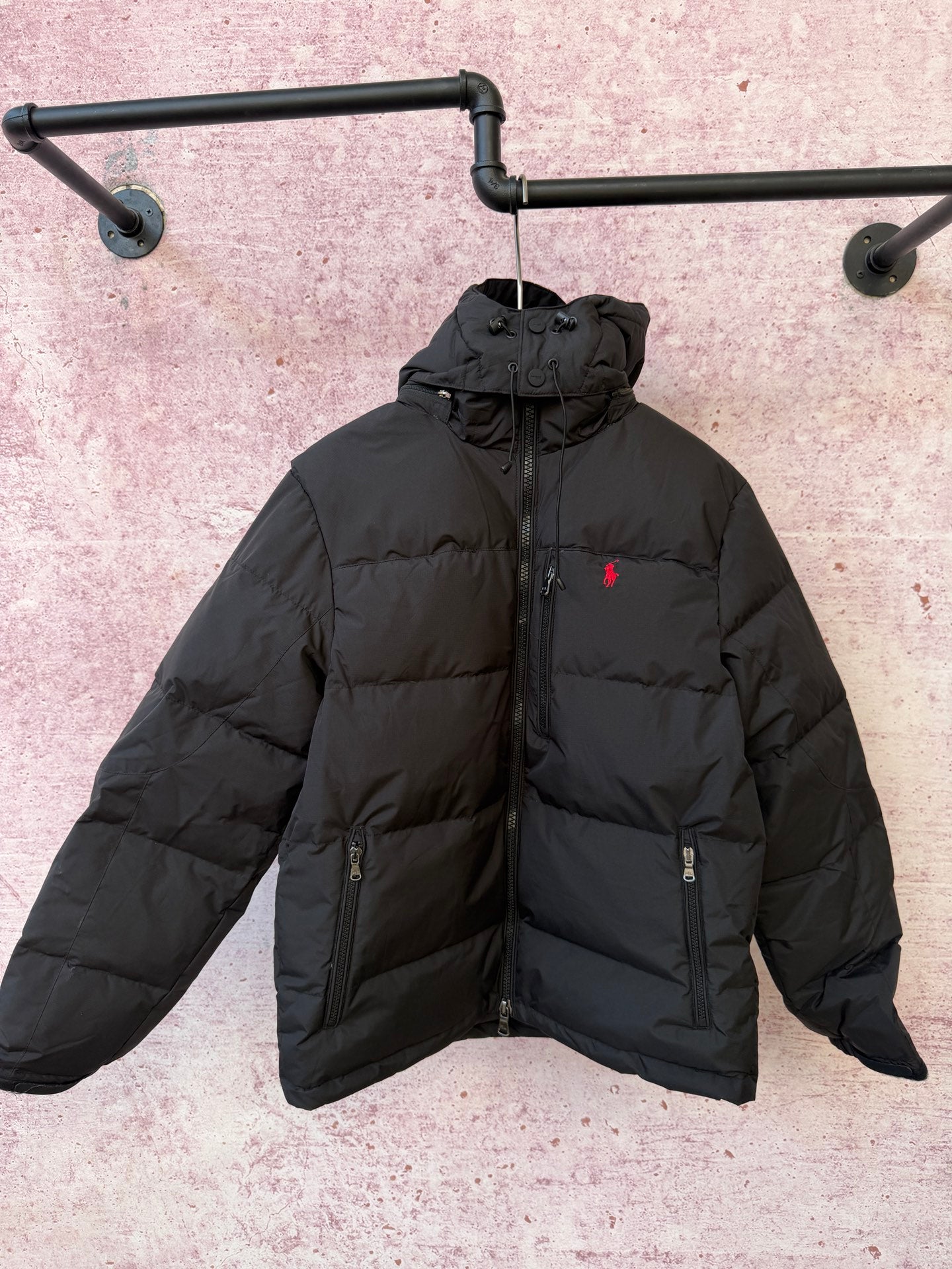 Black hooded puffer jacket with full-zip front and two zip chest pockets