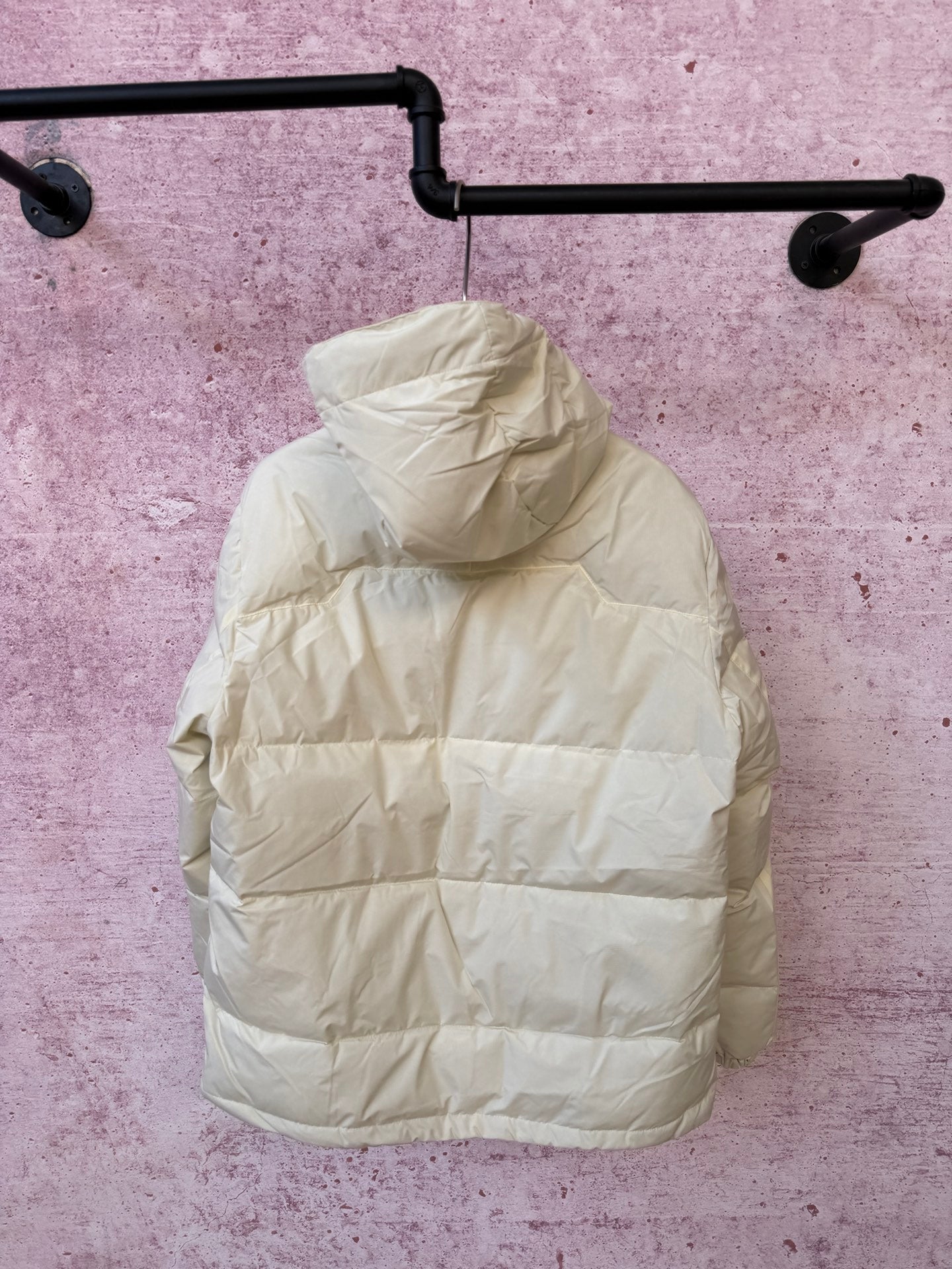 White hooded puffer jacket with full-zip front and padded quilted panels