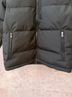 Dark puffer jacket lower panel with quilted baffles and front zipper