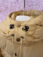 Tan puffer jacket hood with drawstring toggles and center zipper placket
