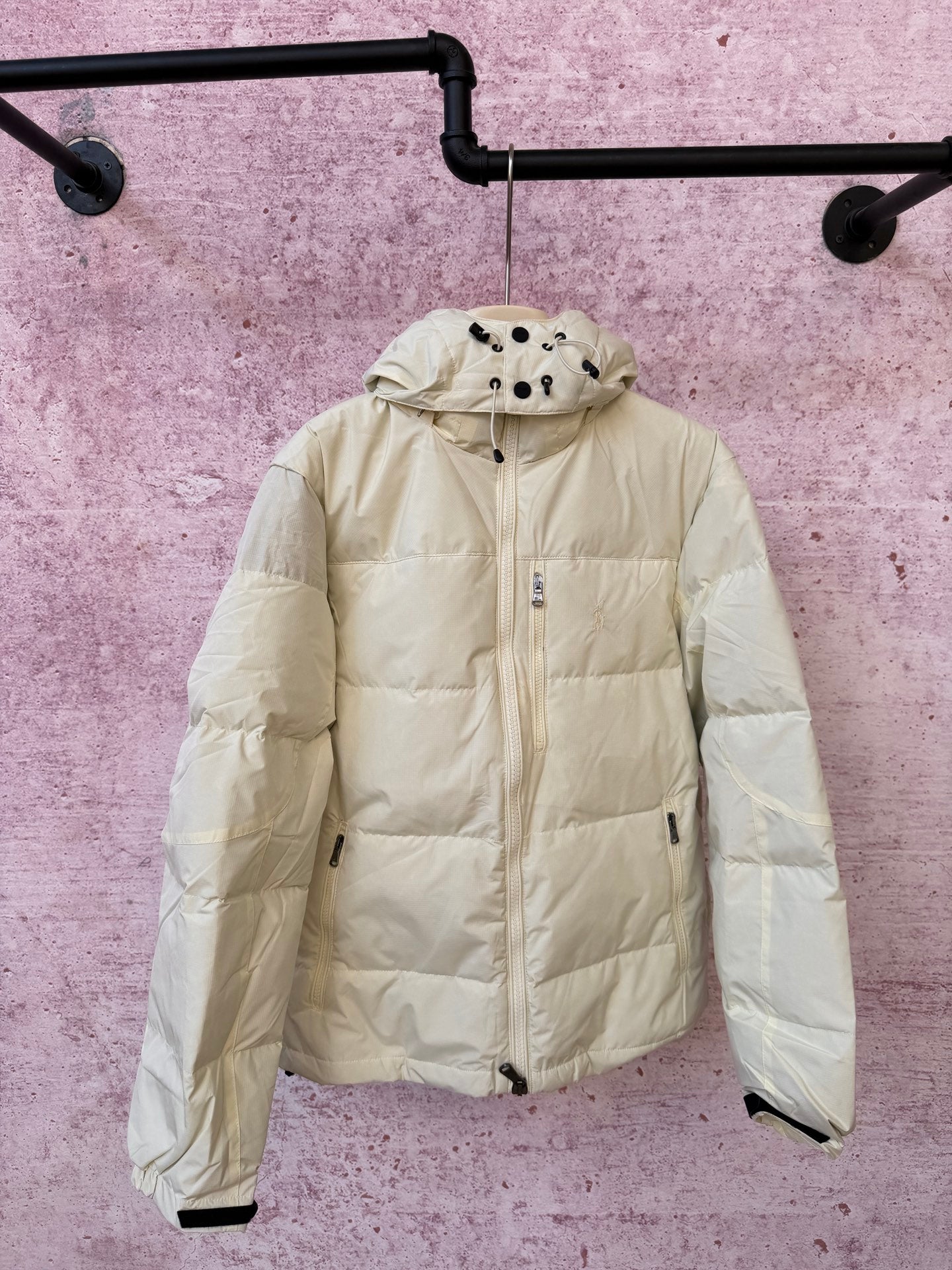 Light cream hooded puffer jacket with full-zip front and zip pocket details